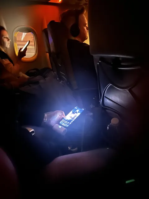 My neighbor on a night flight. She wouldn’t reduce the brightness even after I requested her.