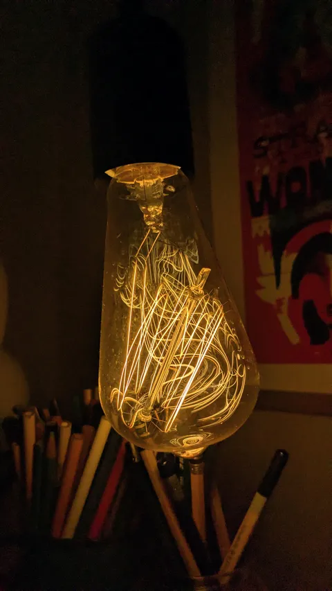 The glass stem that holds the elements broke in this Edison bulb when I dropped it, but the elements didn't break so it still works and looks wonky.