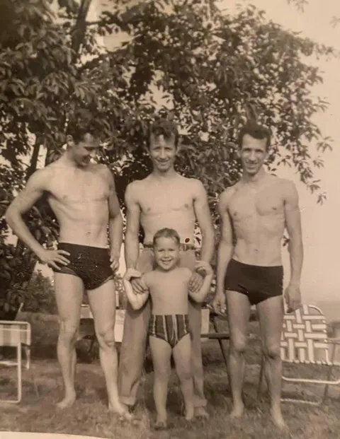 My dad (age 4) with his older brothers (ages 23, 25, and 21) in 1958. 