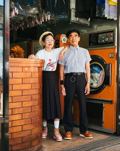 Taiwanese couple wear clothes that were left behind at their laundromat.