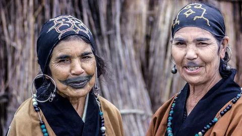 A phot of two members of the Ainu people who are an Indigenous people native to Japan
