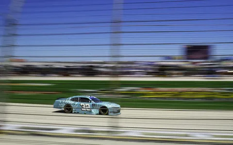 I went to my first NASCAR race today, I shot this photo by turning my body as the car sped by [OC]