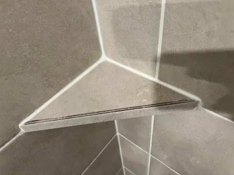 How is this shower shelf made from tile secured?