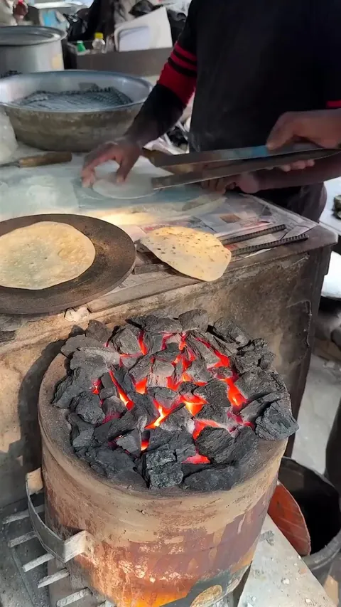 grilling roti on hot charcoal
