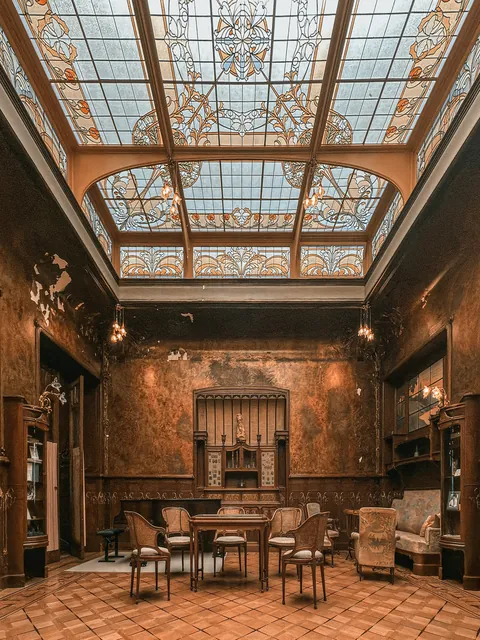 Living room with a glass roof in the Maison Losseau, an 18th-century house renovated in the early 1900s in the Art Nouveau style by Paul Saintenoy, Mons, Wallonia, Belgium.