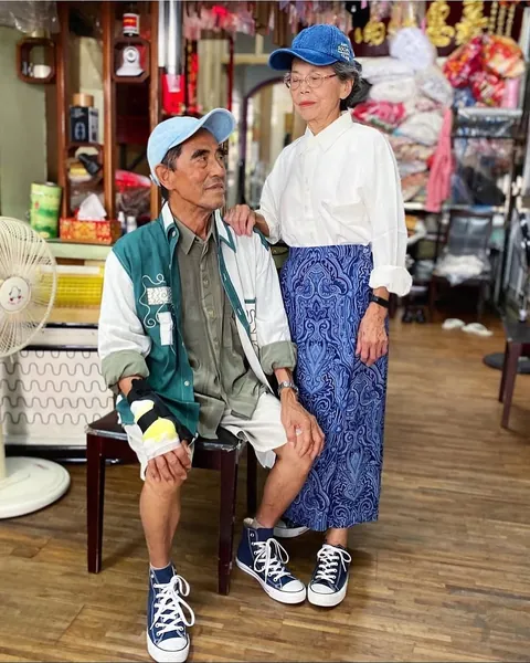 Taiwanese couple wear clothes that were left behind at their laundromat.