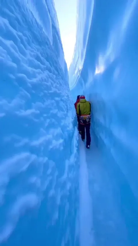 Inside a narrow blue ice canyon in Alaska.