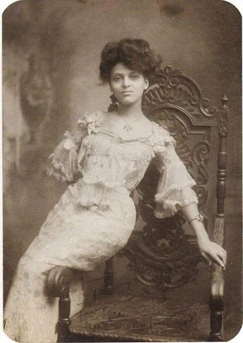 Unknown woman posing casually in a chair, circa 1900s