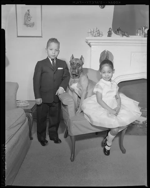 Sharp dressed kids, pose with their dog, 1940. Safety kodak