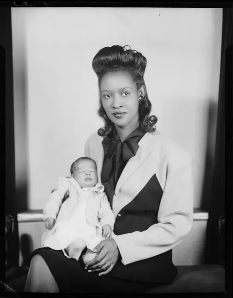 Young mother presenting her baby, circa 1945, kodak safety film.
