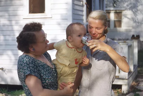 Grandmother on support duty, Mom holding the can, baby making executive decisions (mid 1950s)