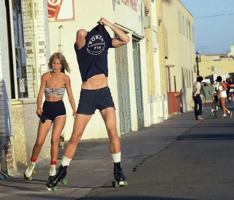 Venice Beach California during the late 1970s roller skate craze. Still has some 70s vibe but you can feel the 80s coming.