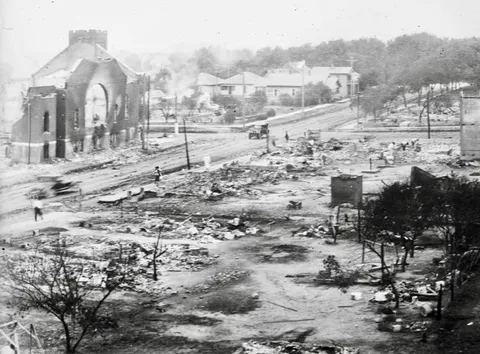 This photo shows the aftermath of the Tulsa Race Massacre (1921), one of the most violent massacres in American history. It occurred in Greenwood, often called the "Black Wall Street." 1,256 houses were burned, and 215 houses were looted, with $27 million of property damages