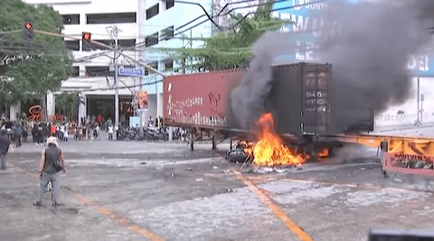 Protesters set fire to a container van at Ayala Bridge