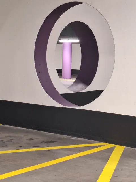 ITAP of two walls in a parking garage, with round gaps in them.