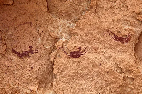 The Cave of the Swimmers features 8,000-year-old depictions of human figures seemingly floating or swimming in the middle of the Sahara Desert