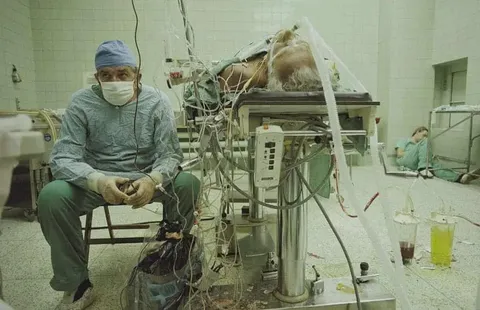 Zbigniew Religa after a 23 hour heart transplant, watching his patient’s vital signs.