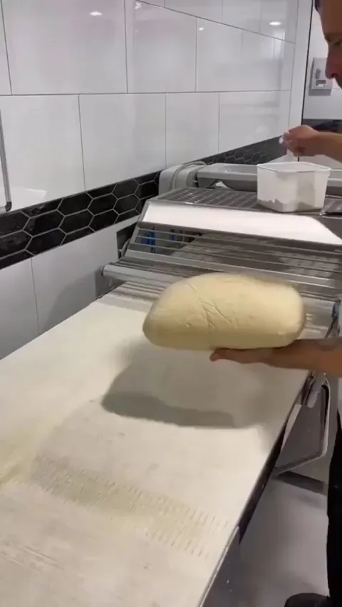A baker making croissants.