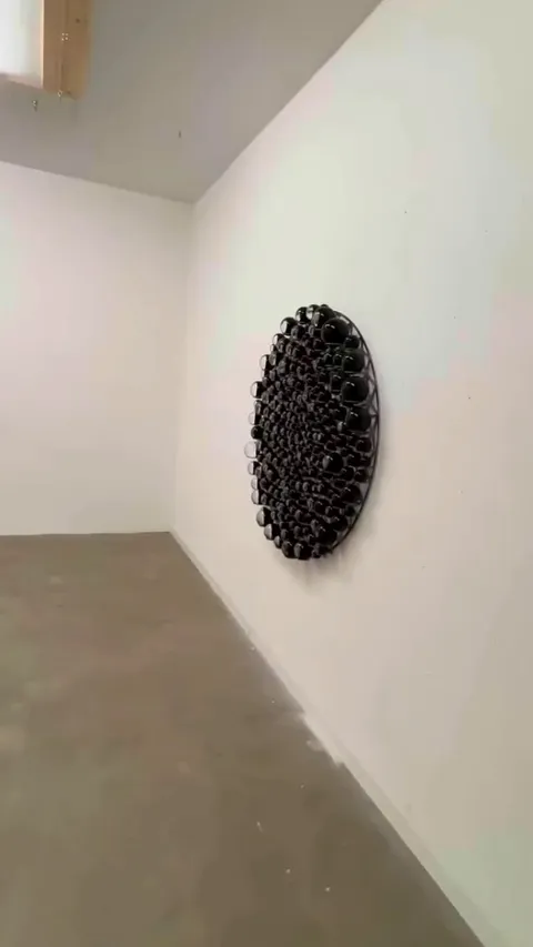 Olafur Eliasson’s 'Iridescent Assembly'—part of his larger 'Rainbow Assembly' series—presents domed glass spheres arranged in a diatom-inspired spiral.