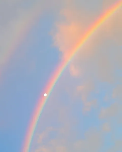 Moon and rainbow in harmony