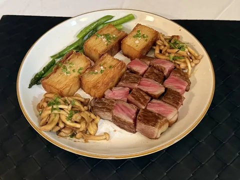 A5 Wagyu with potato pave, miso mushrooms, and a tiny bit of asparagus