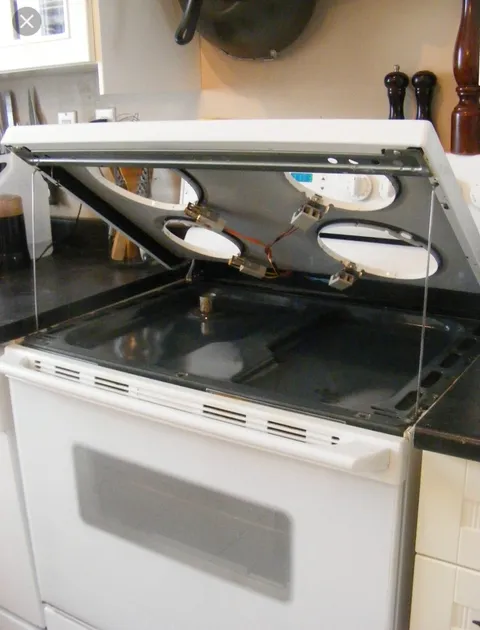 Most electric coil stove tops lift up to clean underneath