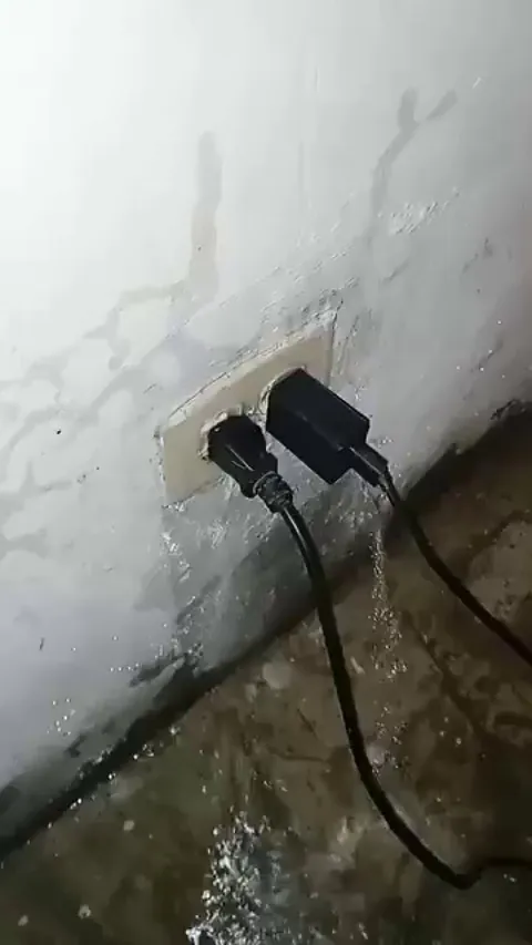Dominican man super surprised because all his electrical outlets are full of water by the rain
