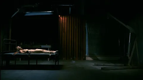 Strapped down tight to the bed with no escape.