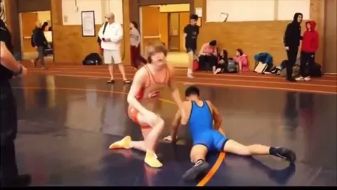 Kid sucker punches other wrestlers after loss.