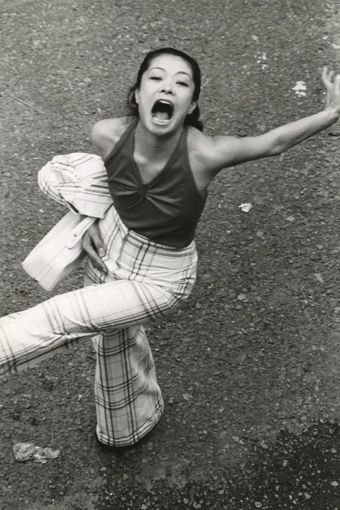 In 1974, Masahisa Fukase photographed his wife, Yōko Wanibe, every morning from the window of their apartment in Tokyo as she left for work.