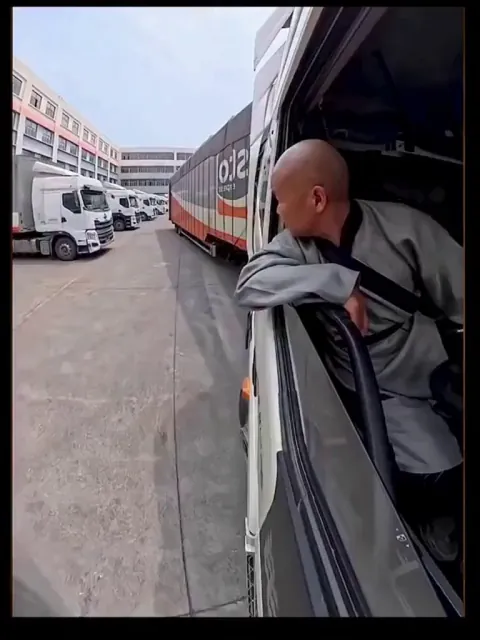 Man reversing a massive 65-foot truck with just inches to spare and making it look effortless.