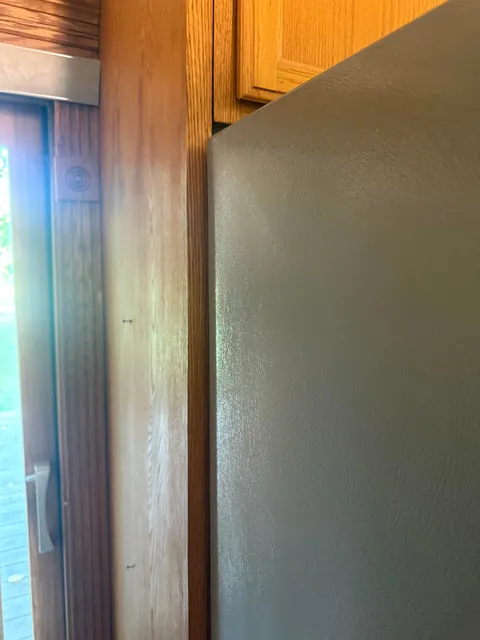 How would you guys go about getting this fridge to fit, it is VERY close.