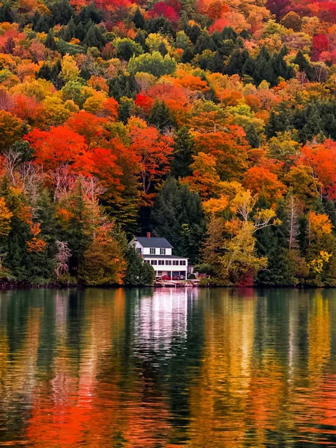 Lake house reflected in the lake, Vermont.