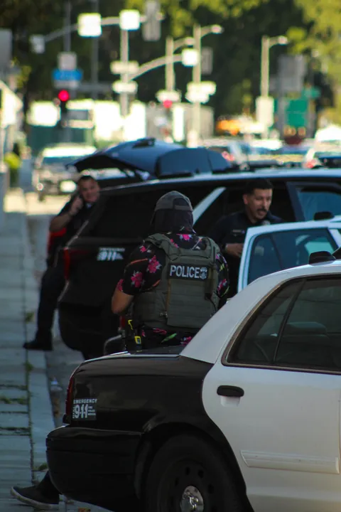 LAPD won’t enforce mask ban; here’s ICE in a POLICE mask, lounging on an LAPD car during arrest [OC]