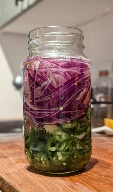 [homemade] Pickled jalapenos, garlic and red onions. Essential fridge staple.