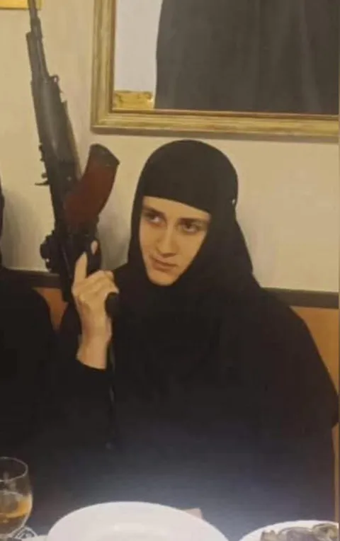 Georgian Orthodox nun with AK-47 rifle.