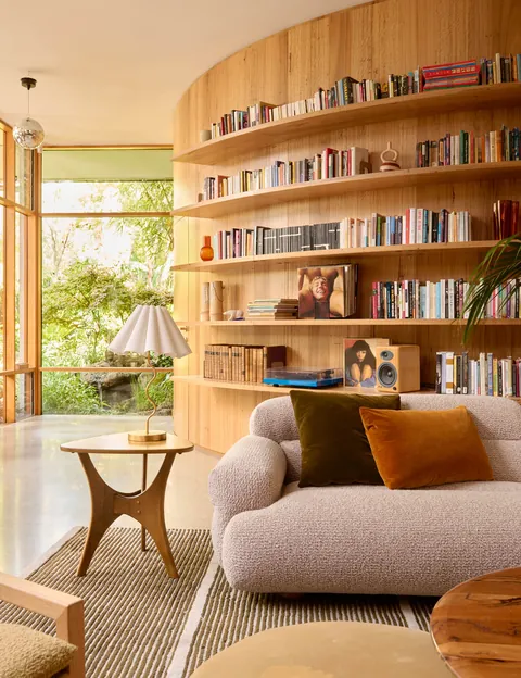 Curved wall with Tasmanian oak shelving in a renovated Fitzroy North residence, Melbourne, Victoria, Australia [4000x5200]