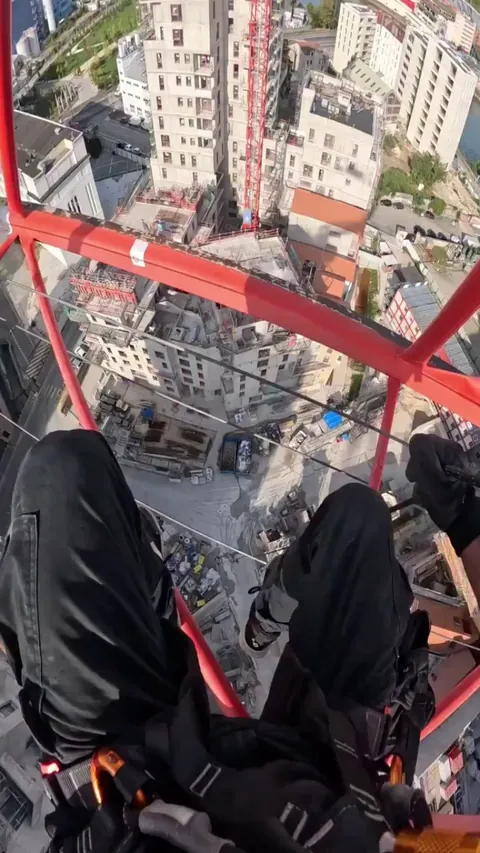 Man sliding down a crane
