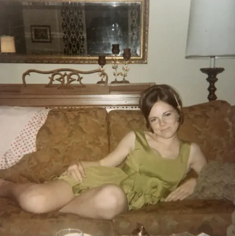 Posing for my boyfriend after our high school dance, 1970