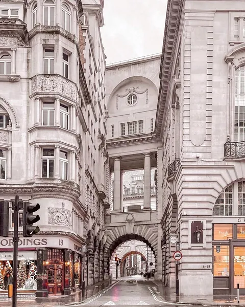 Rusticated arched bridge with a three storey Doric columned loggia above on Air Street near Piccadilly Circus, London, UK.