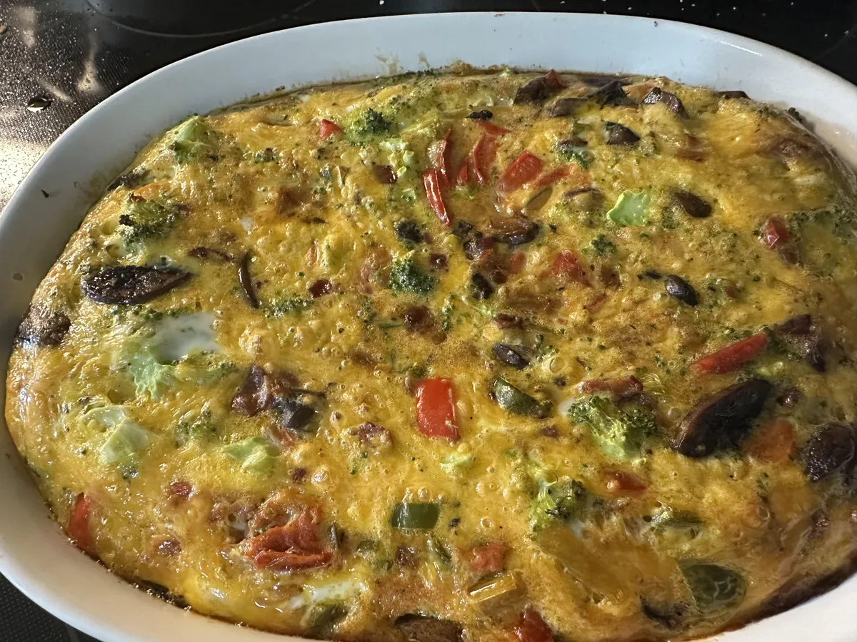 [homemade] Dropped an 18 pack of eggs leaving the supermarket. 9 of them were cracked so I made a big ol’ frittata. Peppers, onions, broccoli, mushrooms, bacon, and cheddar.