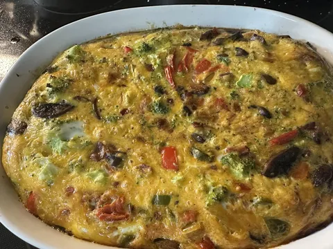 [homemade] Dropped an 18 pack of eggs leaving the supermarket. 9 of them were cracked so I made a big ol’ frittata. Peppers, onions, broccoli, mushrooms, bacon, and cheddar.