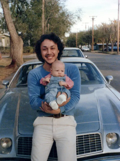 Mom and Dad and their silver  Camaro 1978