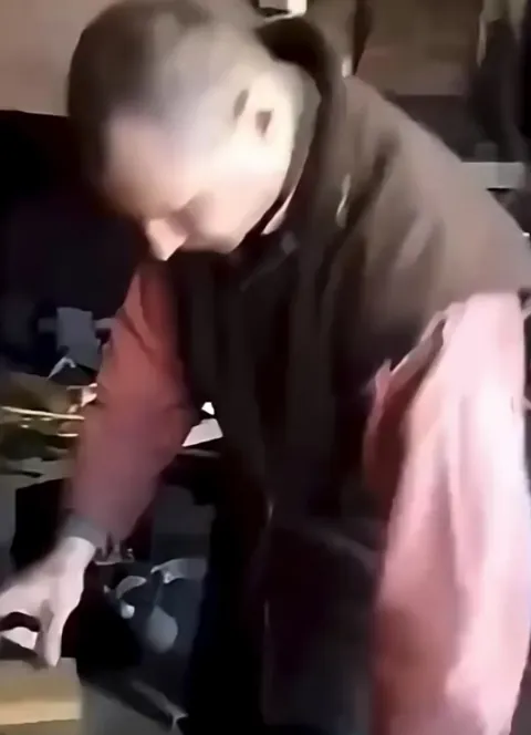 Man creating fire using a hammer