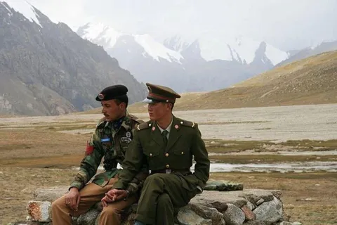 A Chinese and a Pakistani border guard, somewhere in the Himalayas
