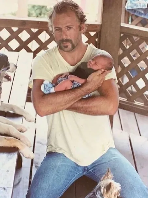 Bruce Willis holding baby Rumer Glenn Willis in 1988