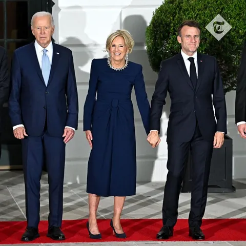 Pictured: Emmanuel Macron holds hands with Jill Biden alongside Joe Biden at the Nato summit in Washington