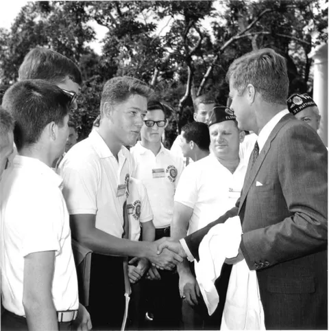 A young Bill Clinton shaking President Kennedy's hand