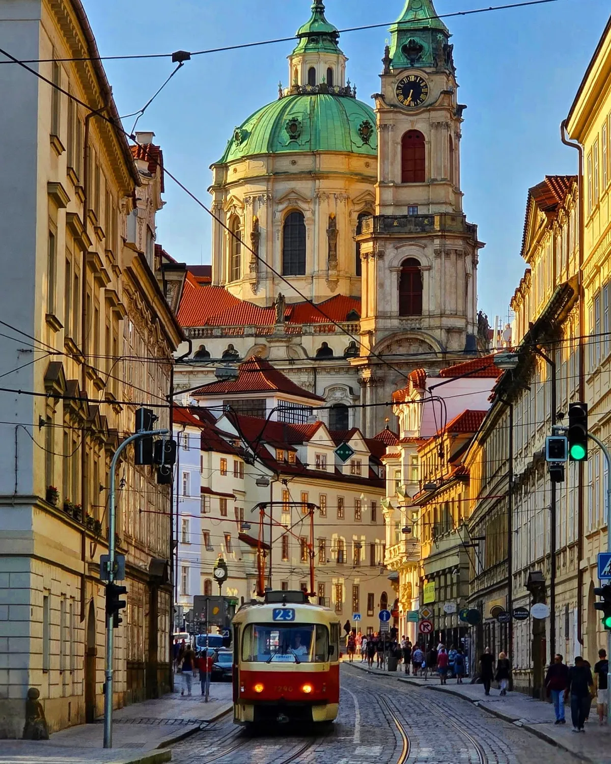 Dome and tower of the 1755 Baroque-style Church of Saint Nicholas towering over a street in the Lesser Town of Prague, Czech Republic.