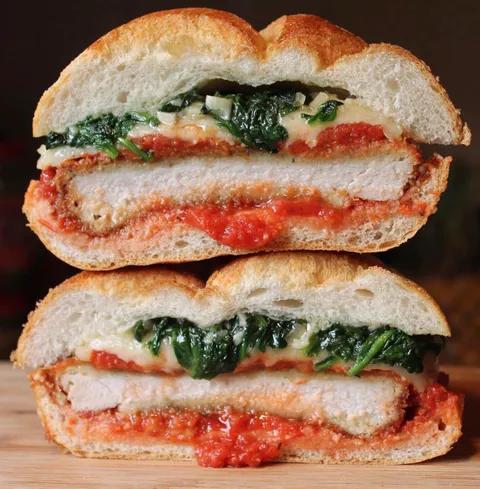 [Homemade] Chicken parm sammy with sautéed baby spinach and garlic.